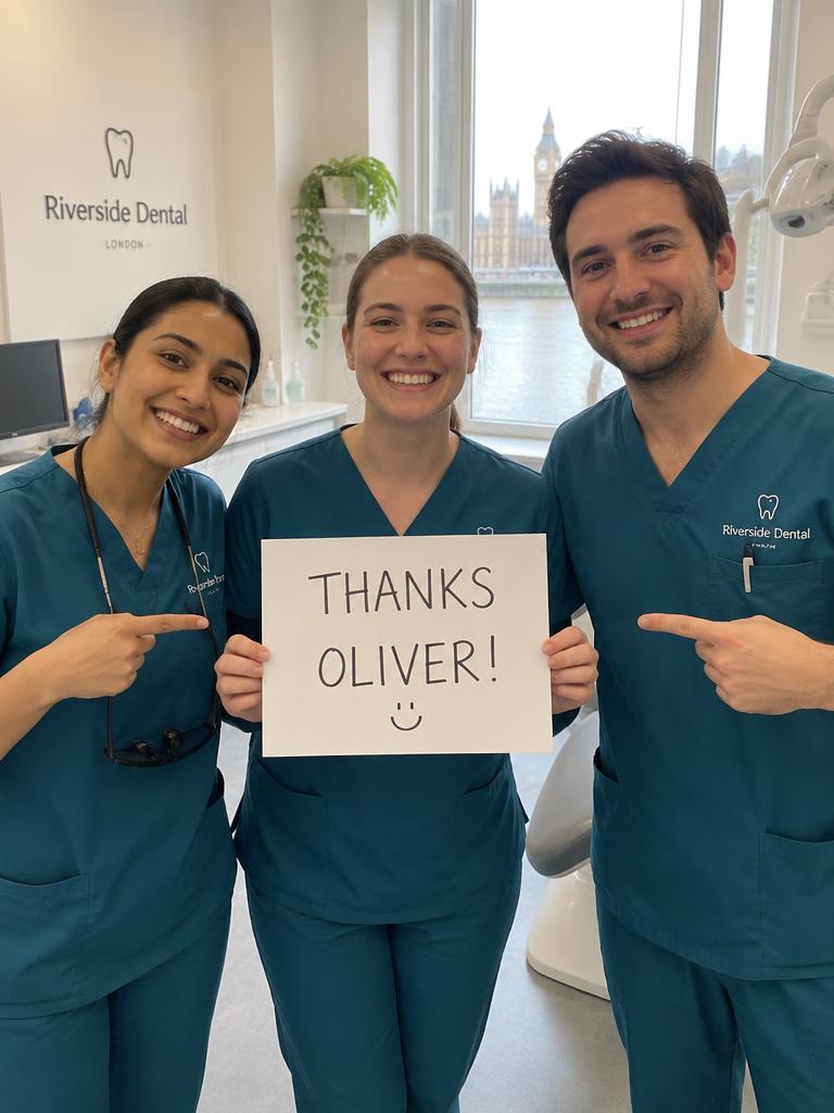 Dental team member holding a personalised thank-you sign